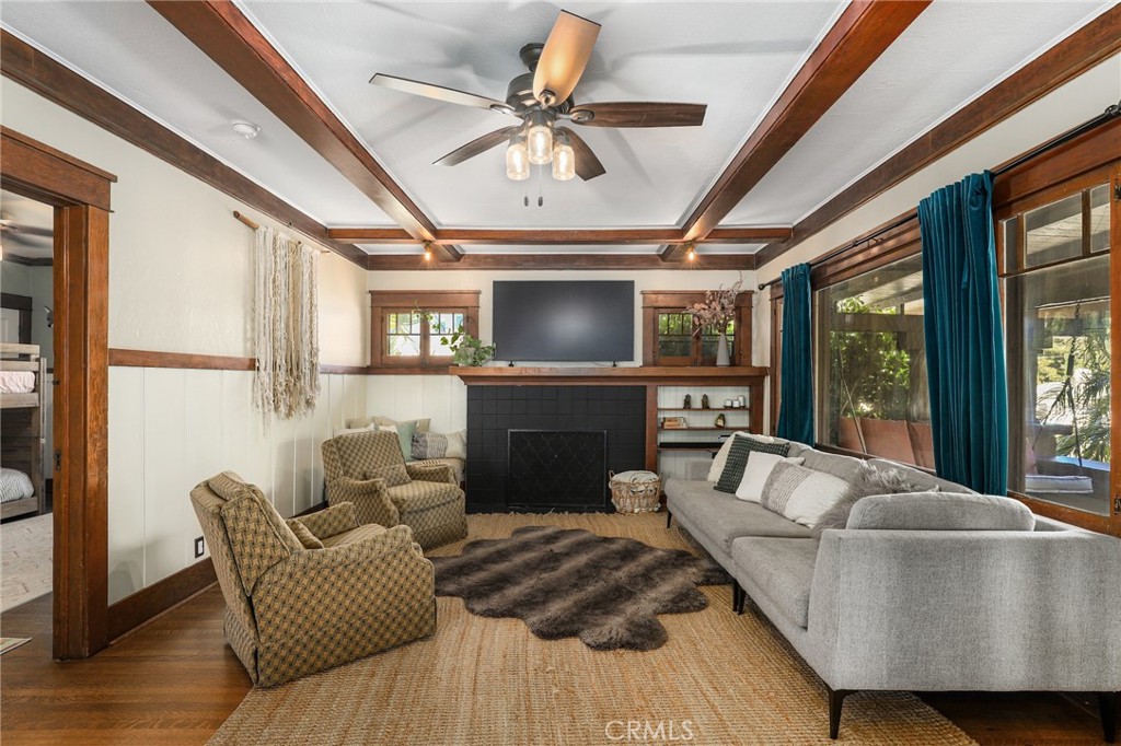 Grand Living Room with wood beamed adorned ceiling and shiplap walls....it truly is a work of art!