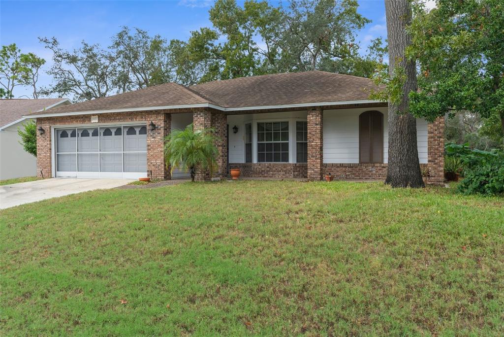 a front view of a house with a yard and porch