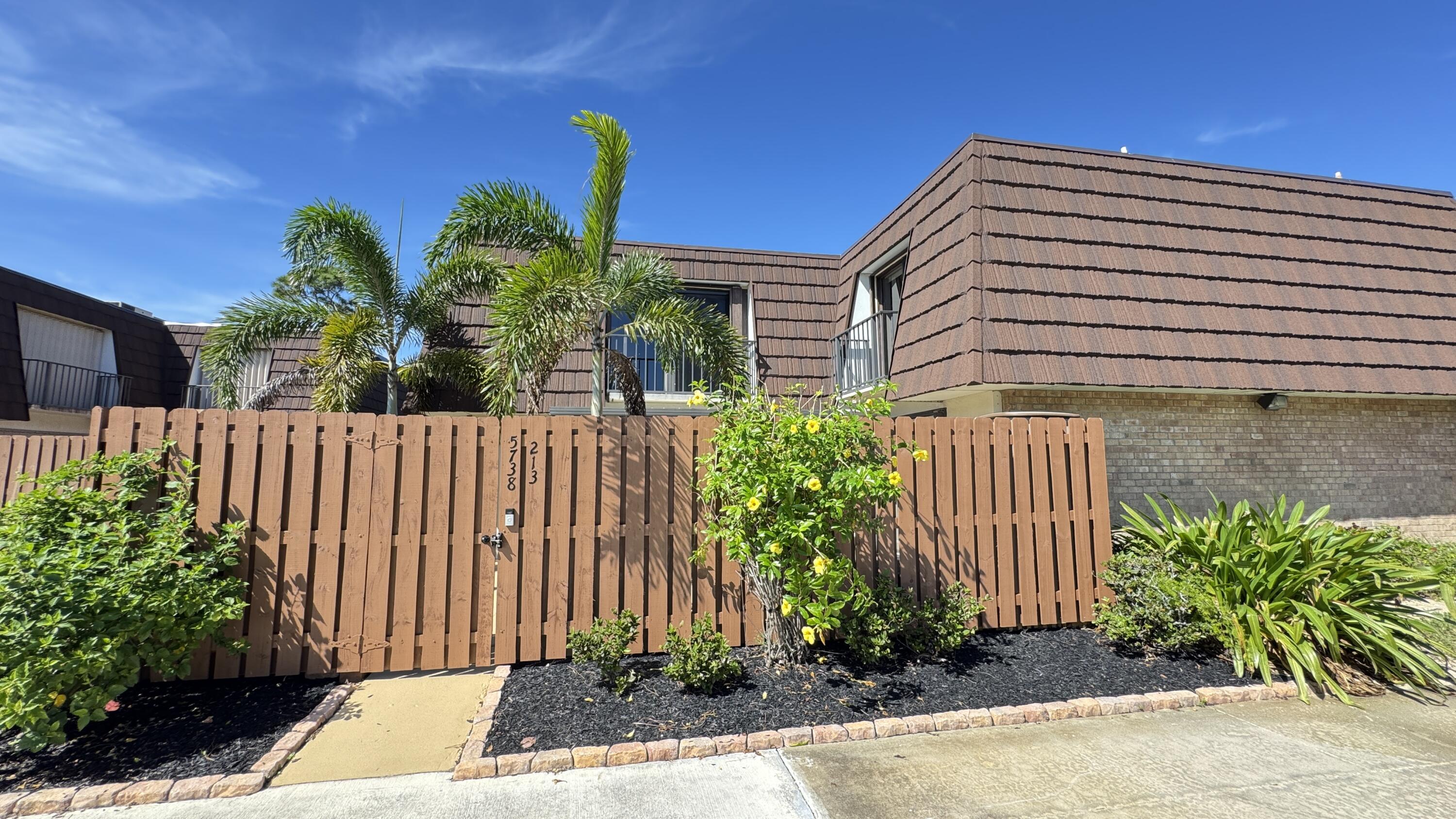 a side view of a house with a garden