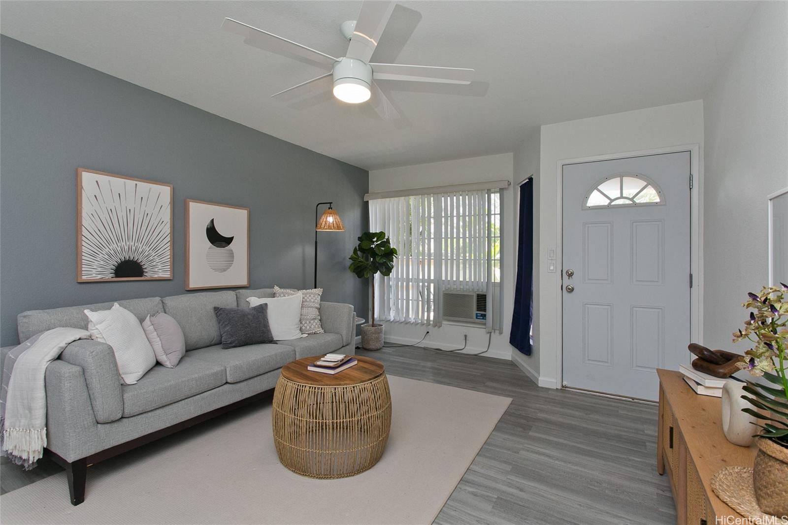 a living room with furniture and a chandelier