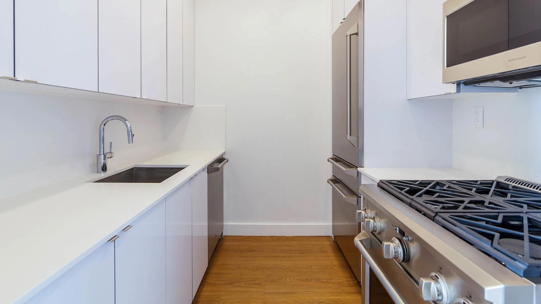 a kitchen with a sink stove and cabinets