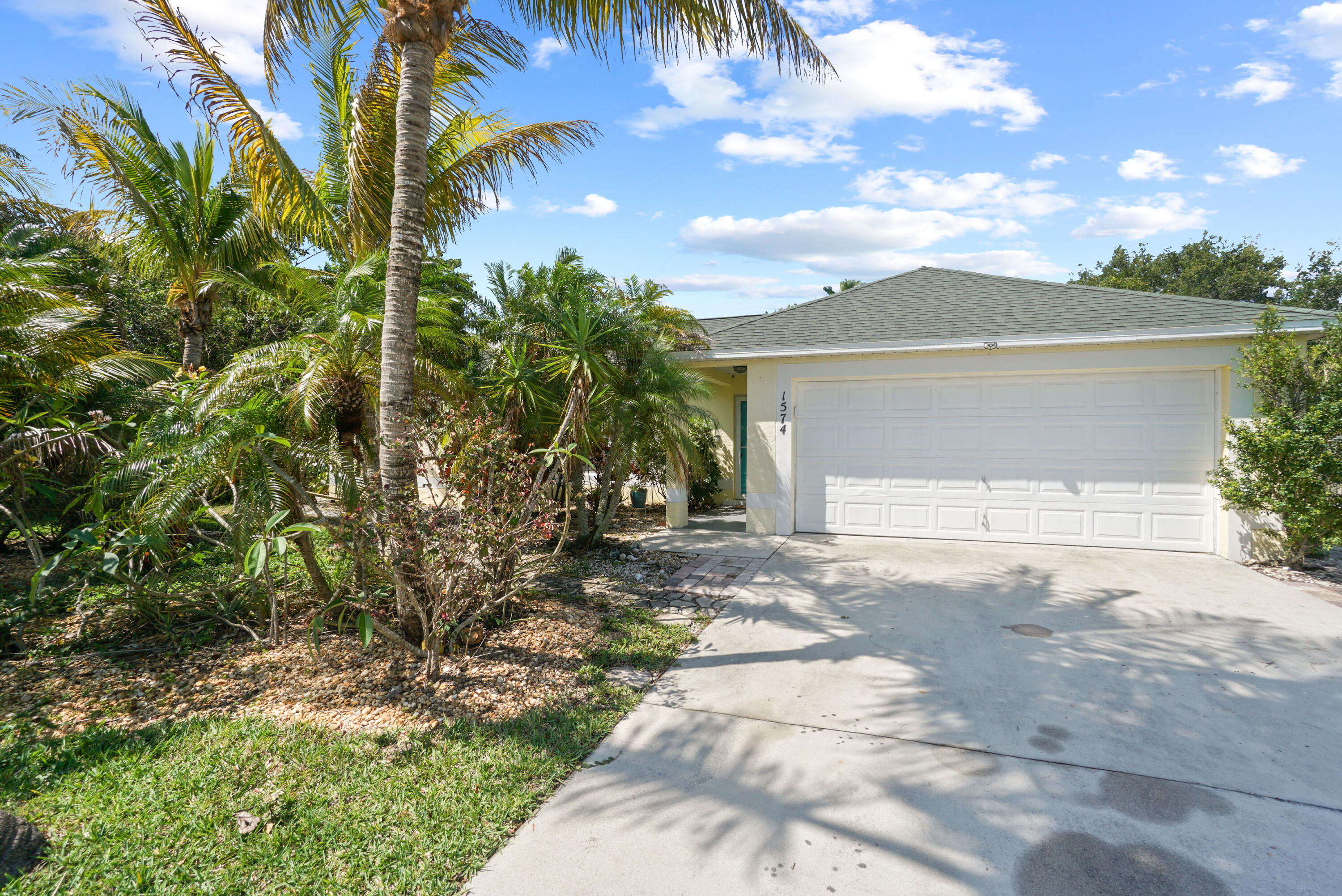 a front view of a house with a yard and a garage