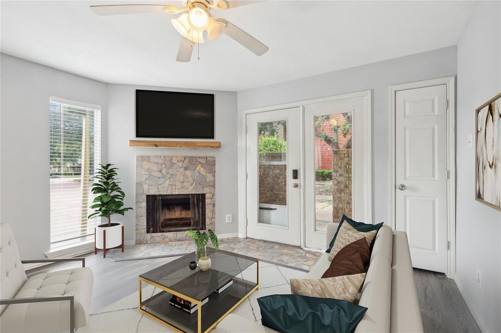 a living room with furniture fireplace and window