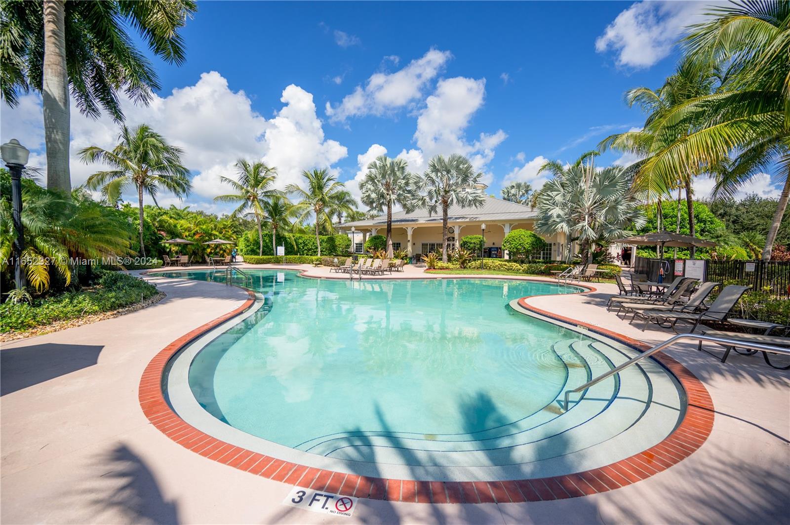 a view of a swimming pool with outdoor seating