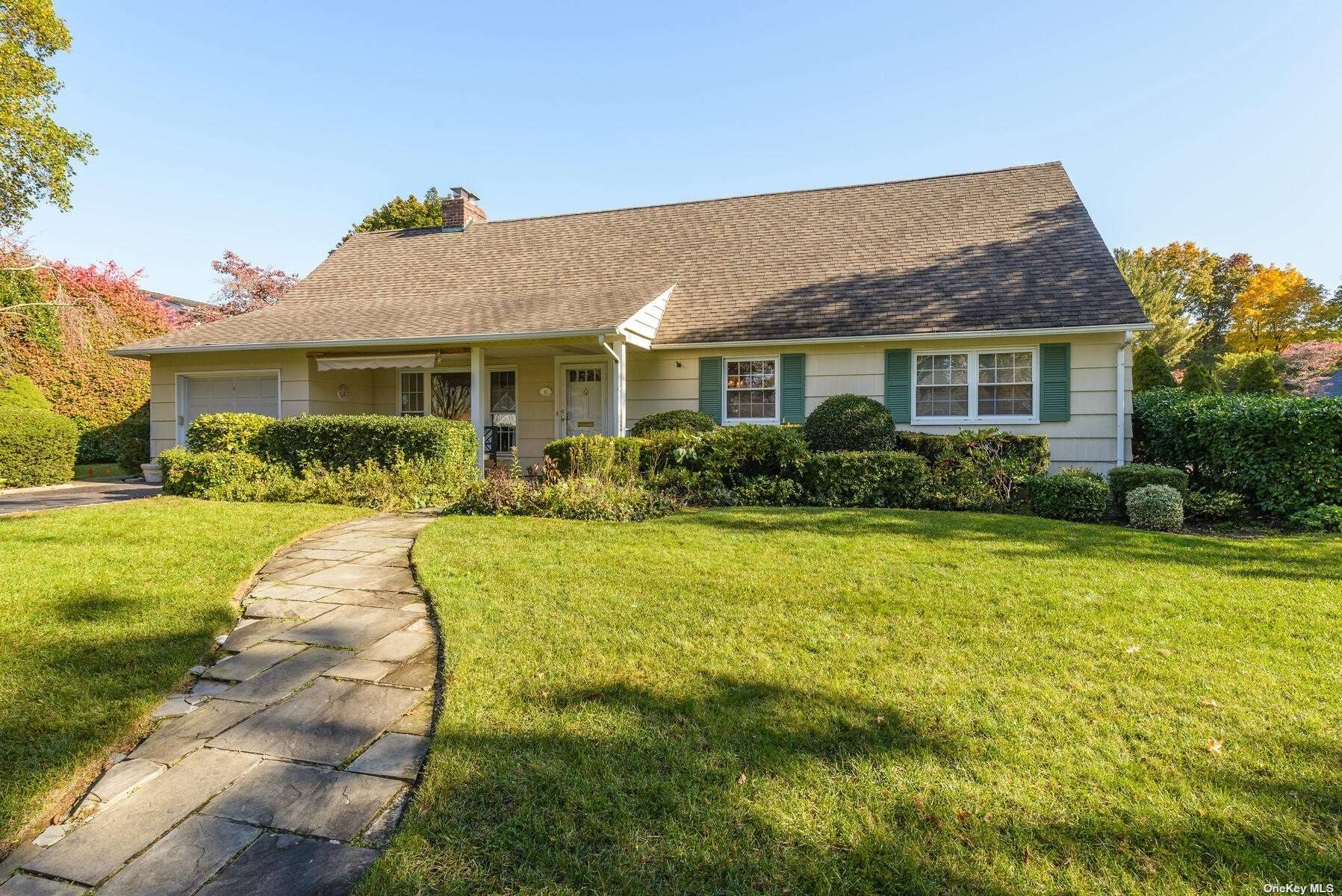 a front view of house with yard and green space