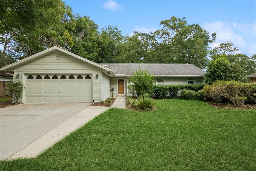 a front view of a house with a yard and garage