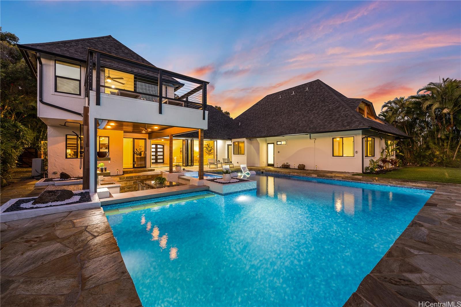 a view of a house with swimming pool and sitting area