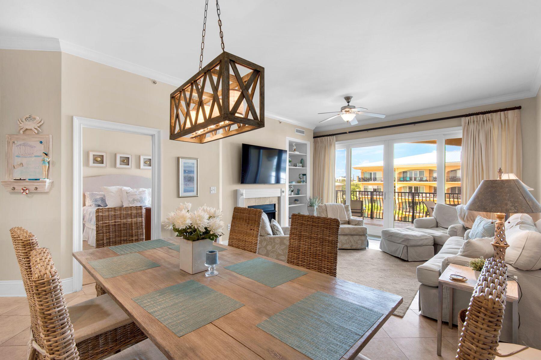 a living room with fireplace furniture and a large window