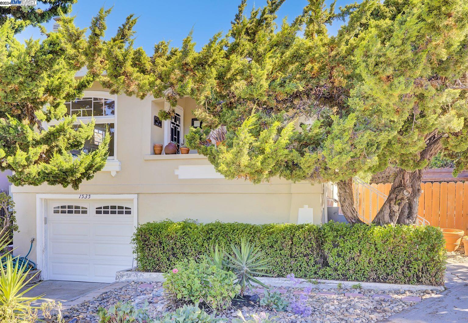 front view of a house with a tree