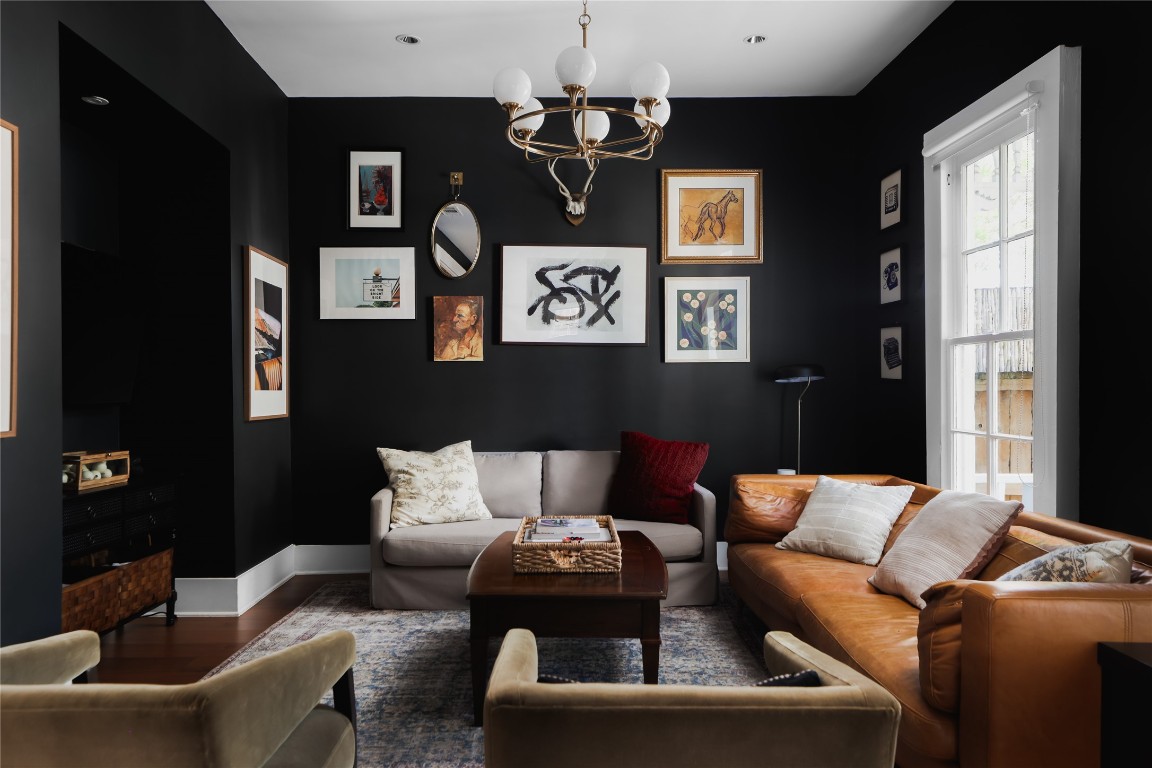 a living room with furniture a chandelier and a window