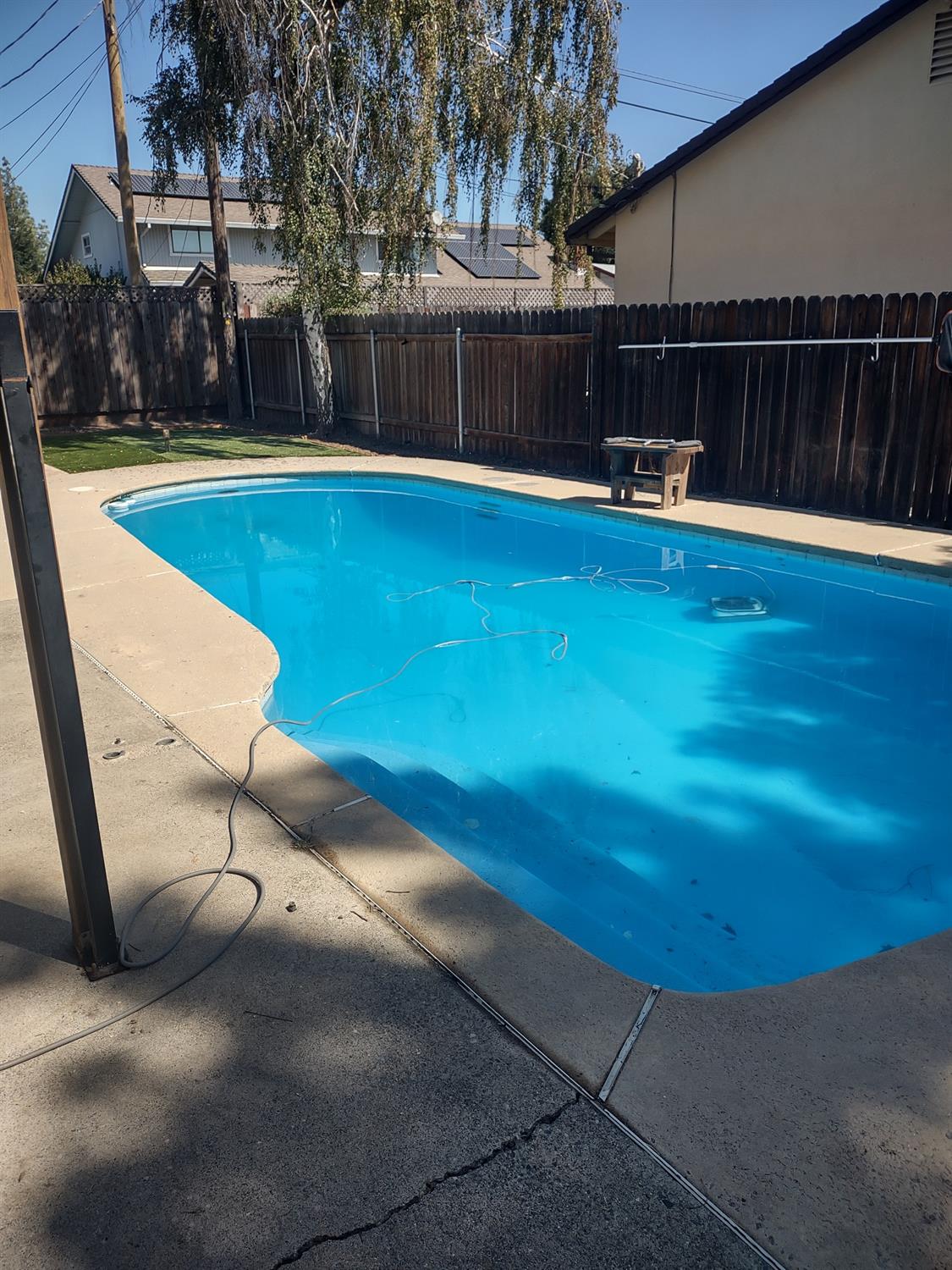 a view of a swimming pool with a yard