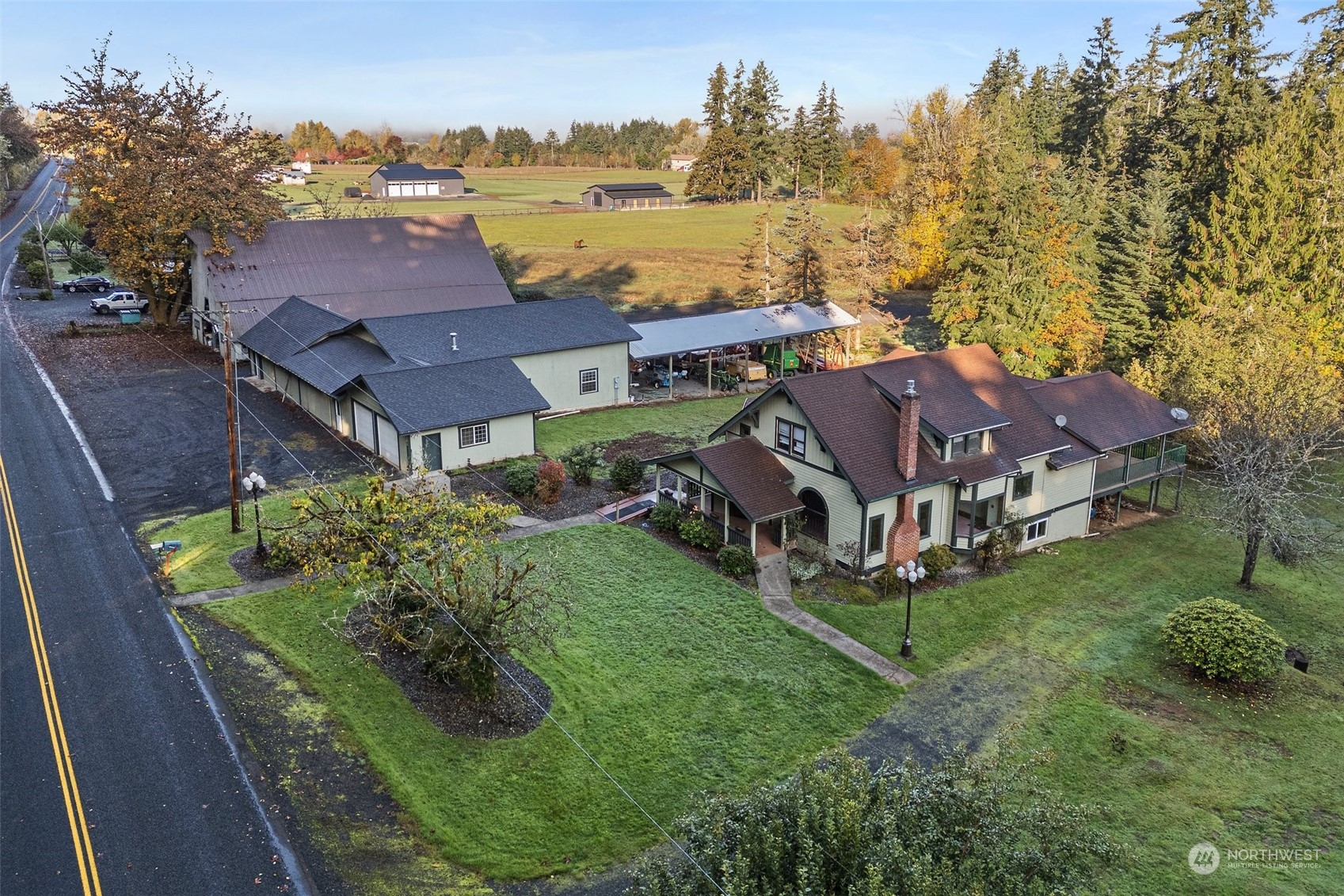 an aerial view of residential houses with outdoor space and trees