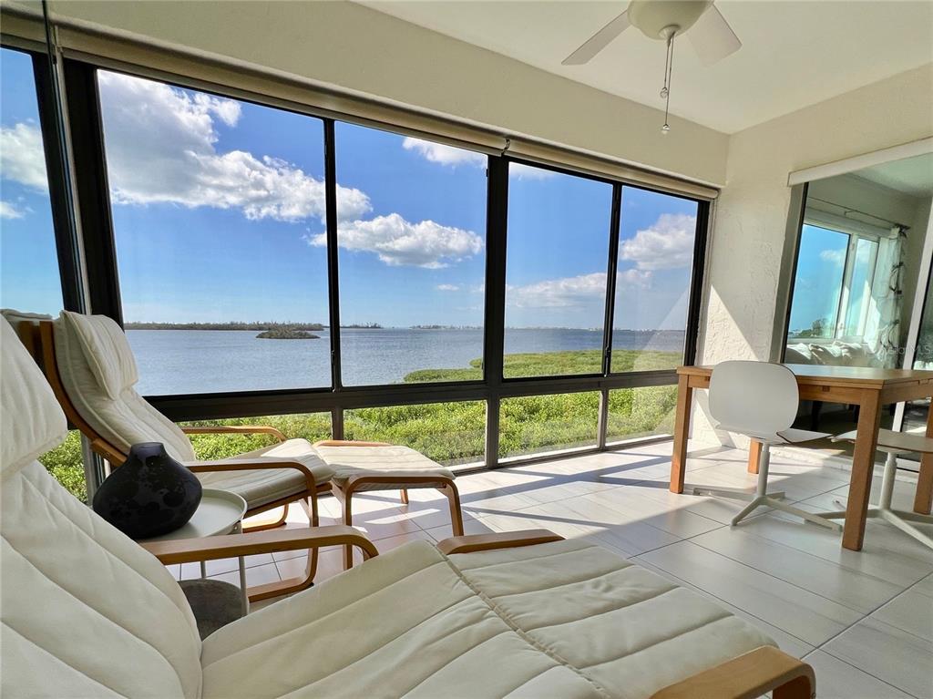 a living room with large window and a table