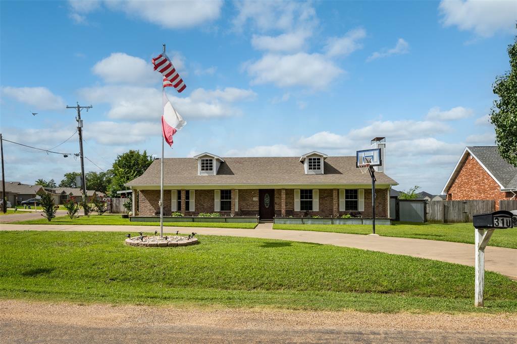 a front view of a building with a yard