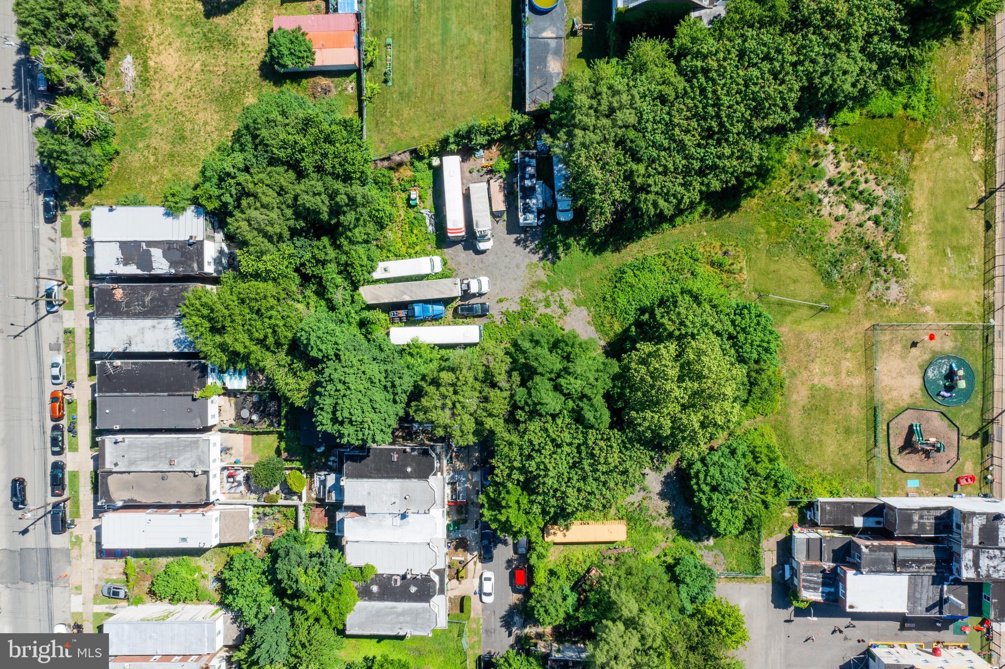 an aerial view of a house with garden space and street view