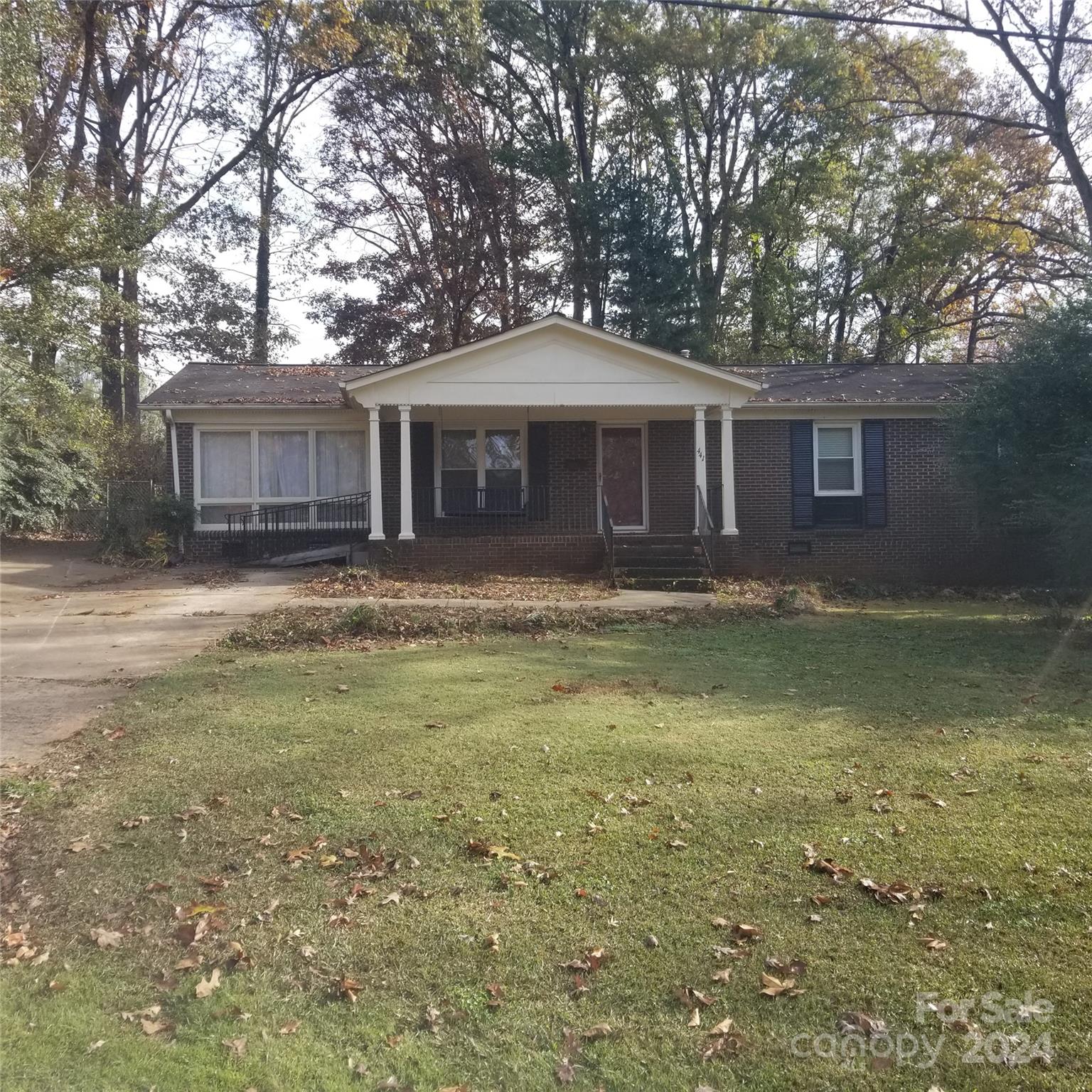 a front view of house with yard and trees