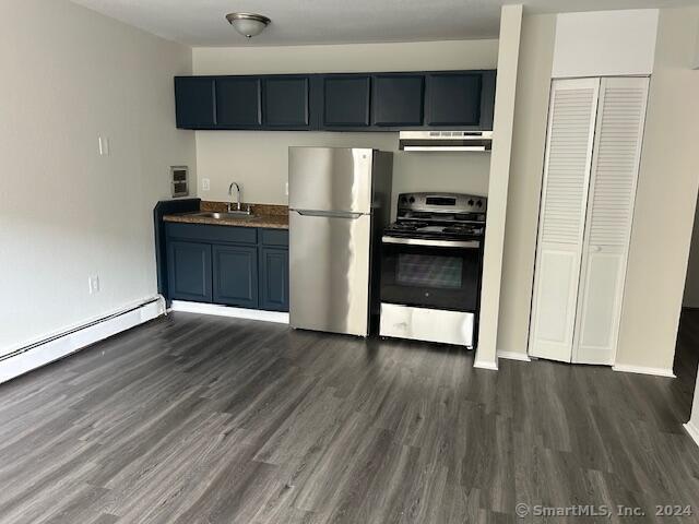 a kitchen with a refrigerator and a stove top oven