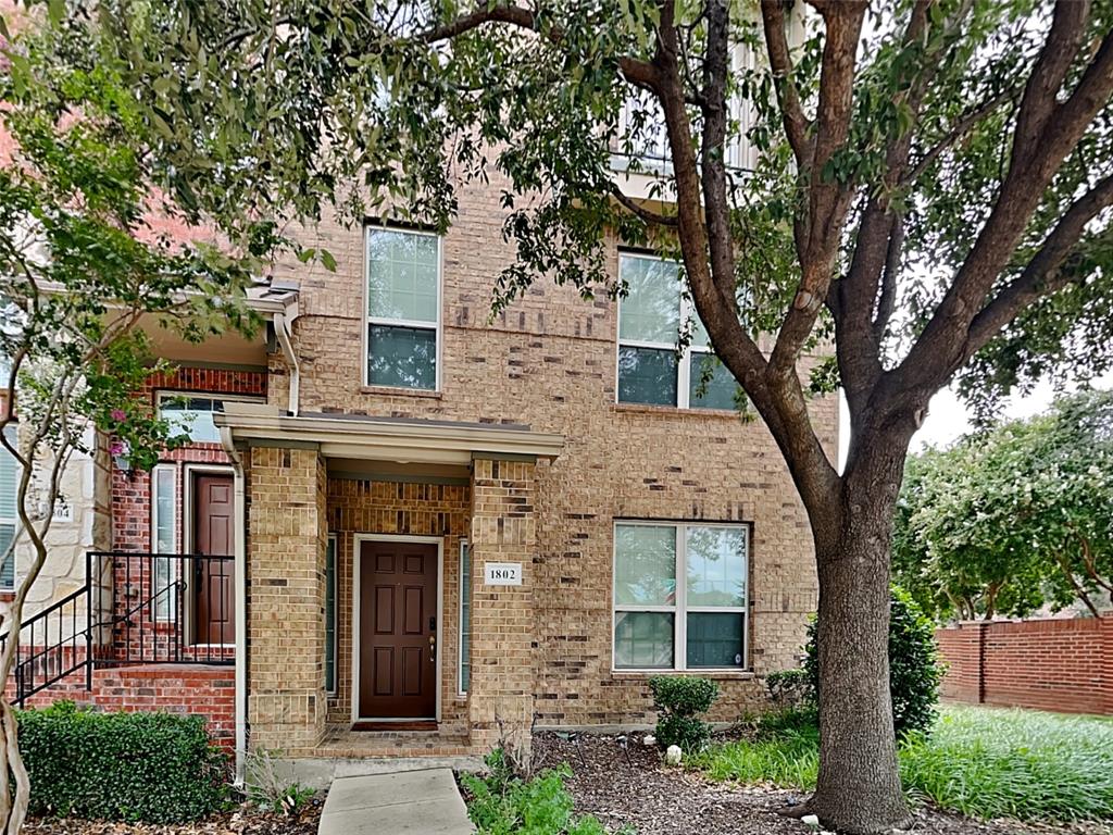 front view of a house with a tree