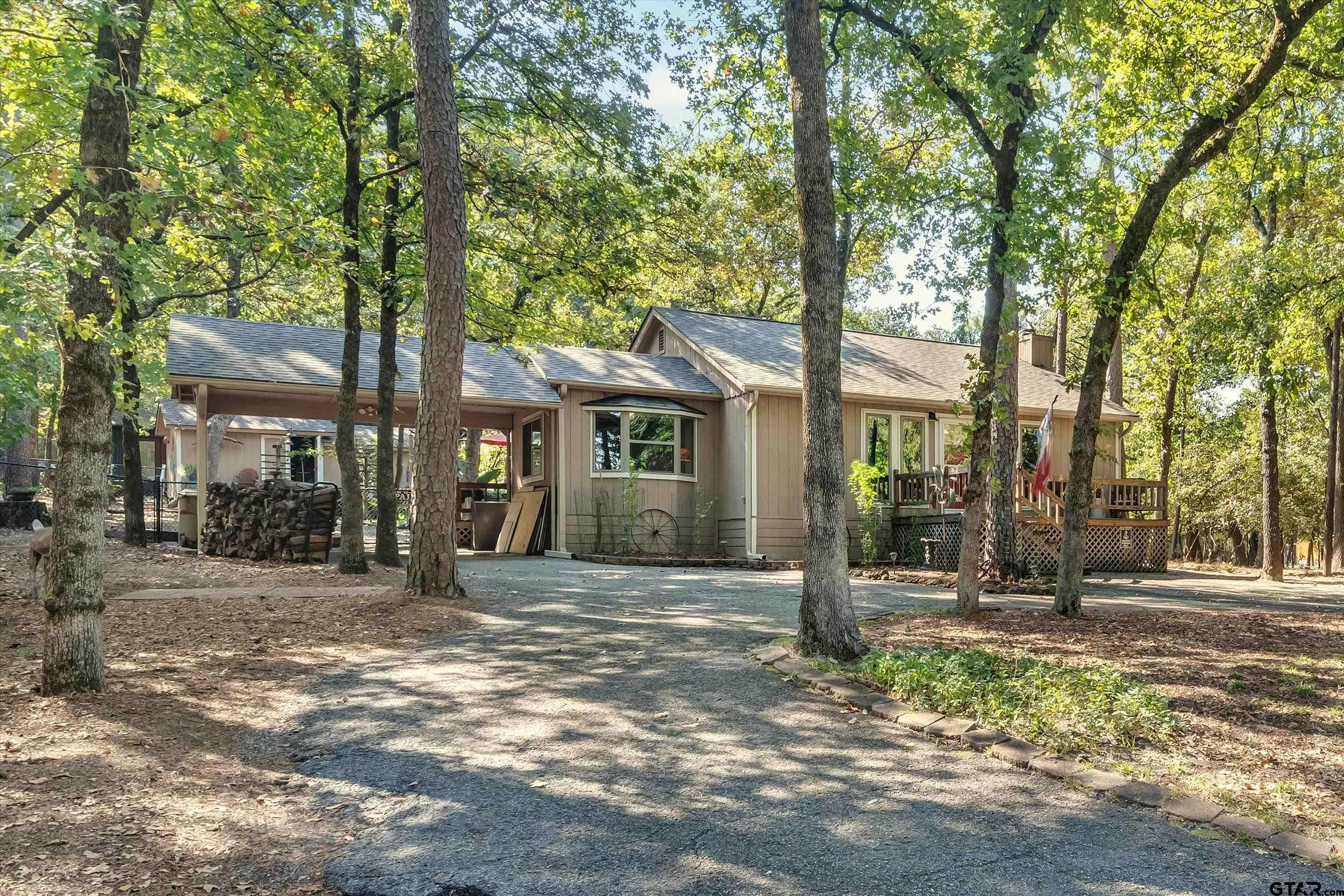 a front view of a house with a tree in front