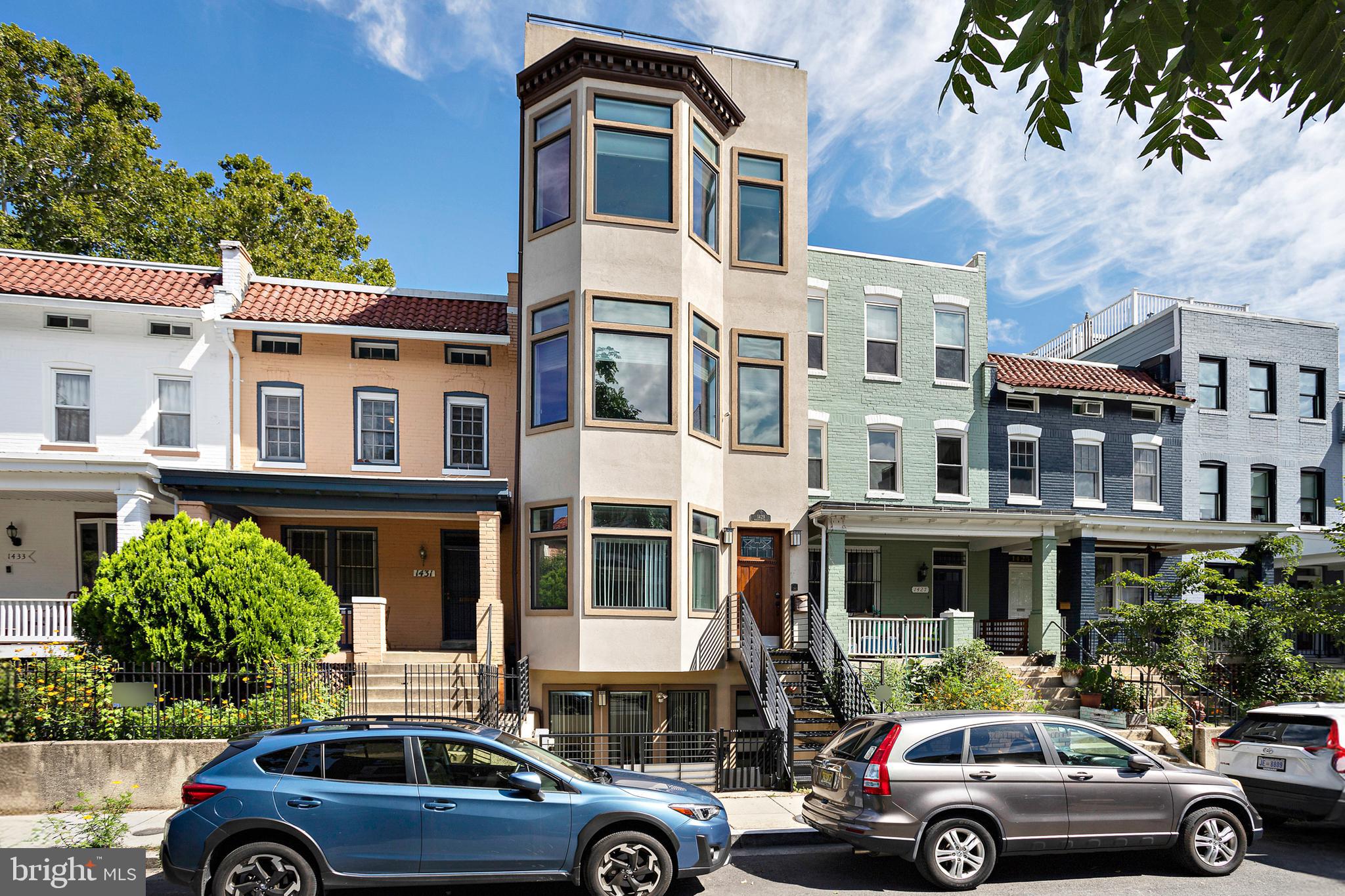 a view of cars parked in front of a brick building