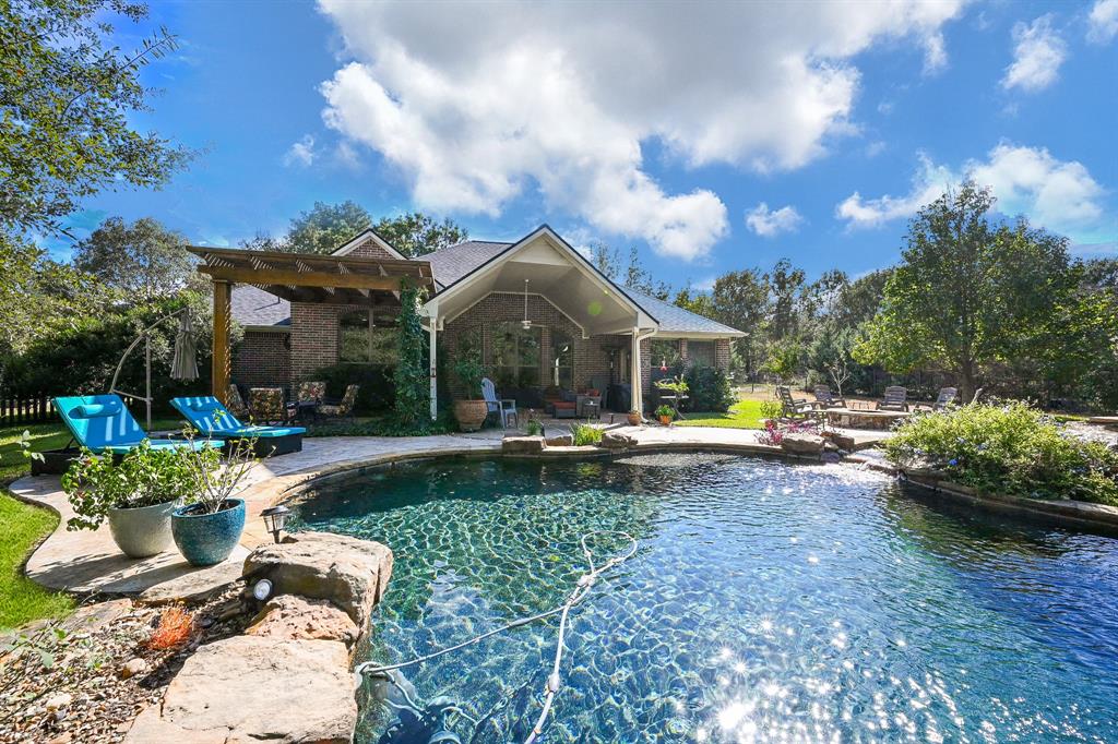 a view of a house with backyard sitting area and garden