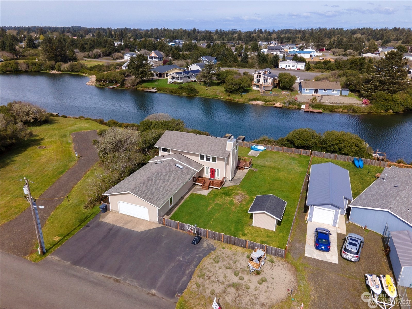 an aerial view of residential houses with outdoor space and lake view