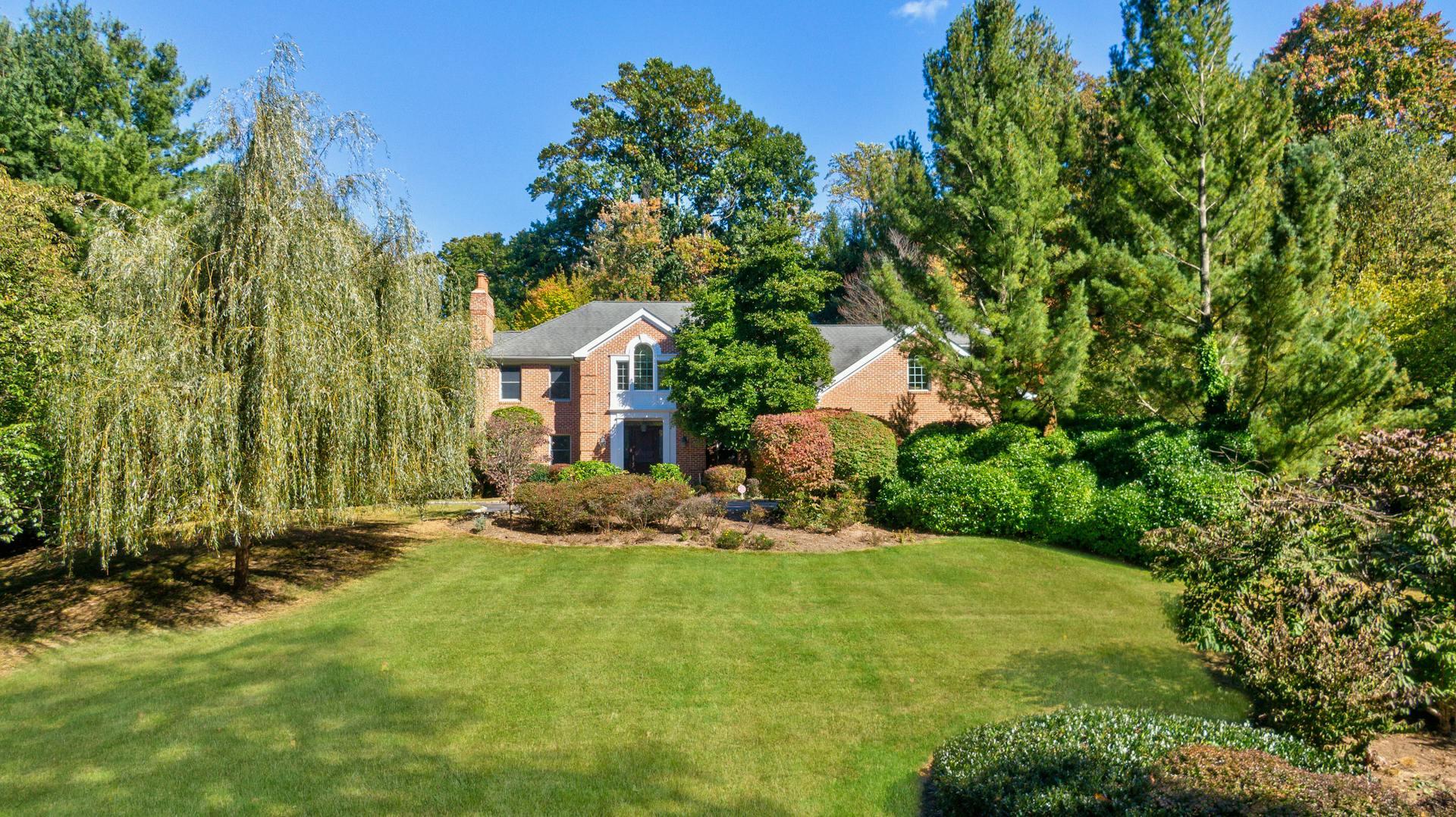 a view of a house with backyard and sitting area