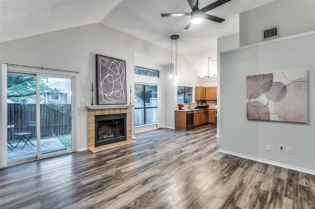 a view of a kitchen with furniture a fireplace and wooden floor