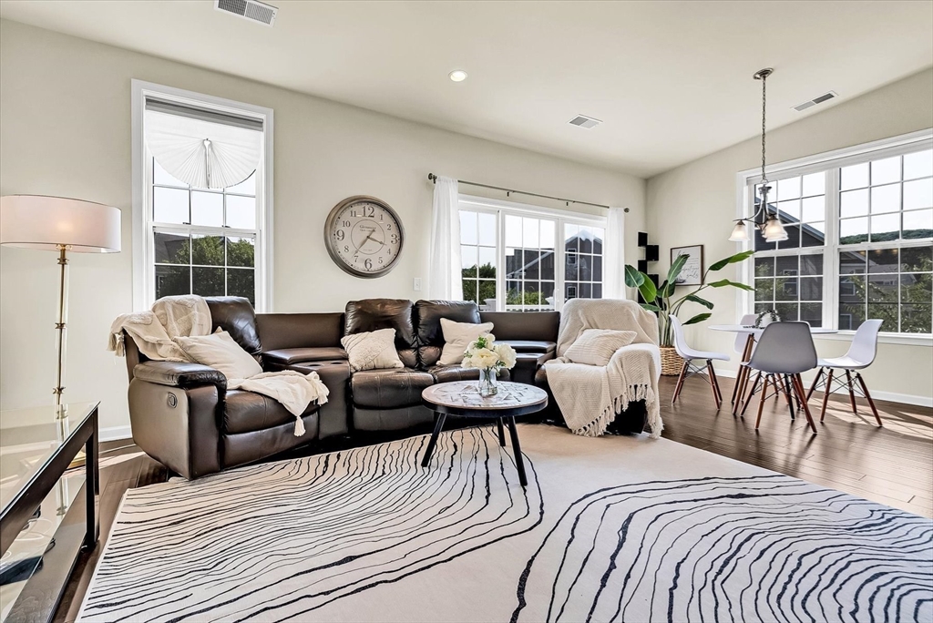 a living room with furniture a table and a large window