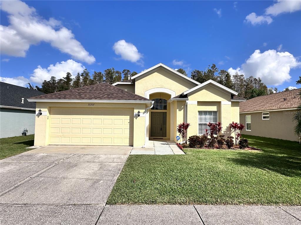 a front view of a house with a yard