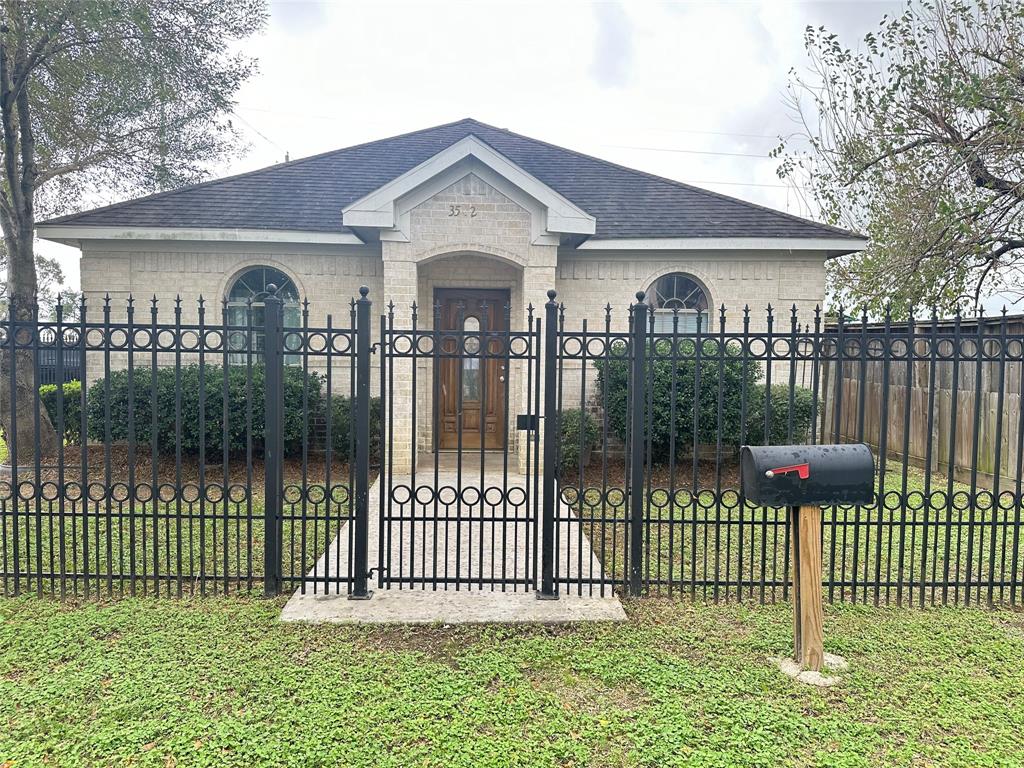 a front view of a house with a garden and deck