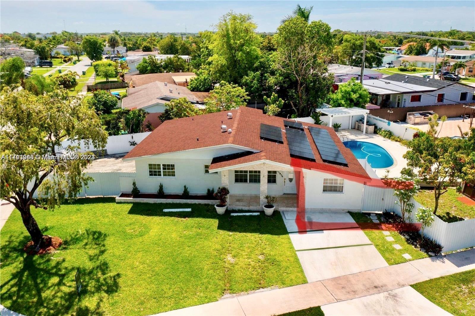 a aerial view of a house with swimming pool garden and patio