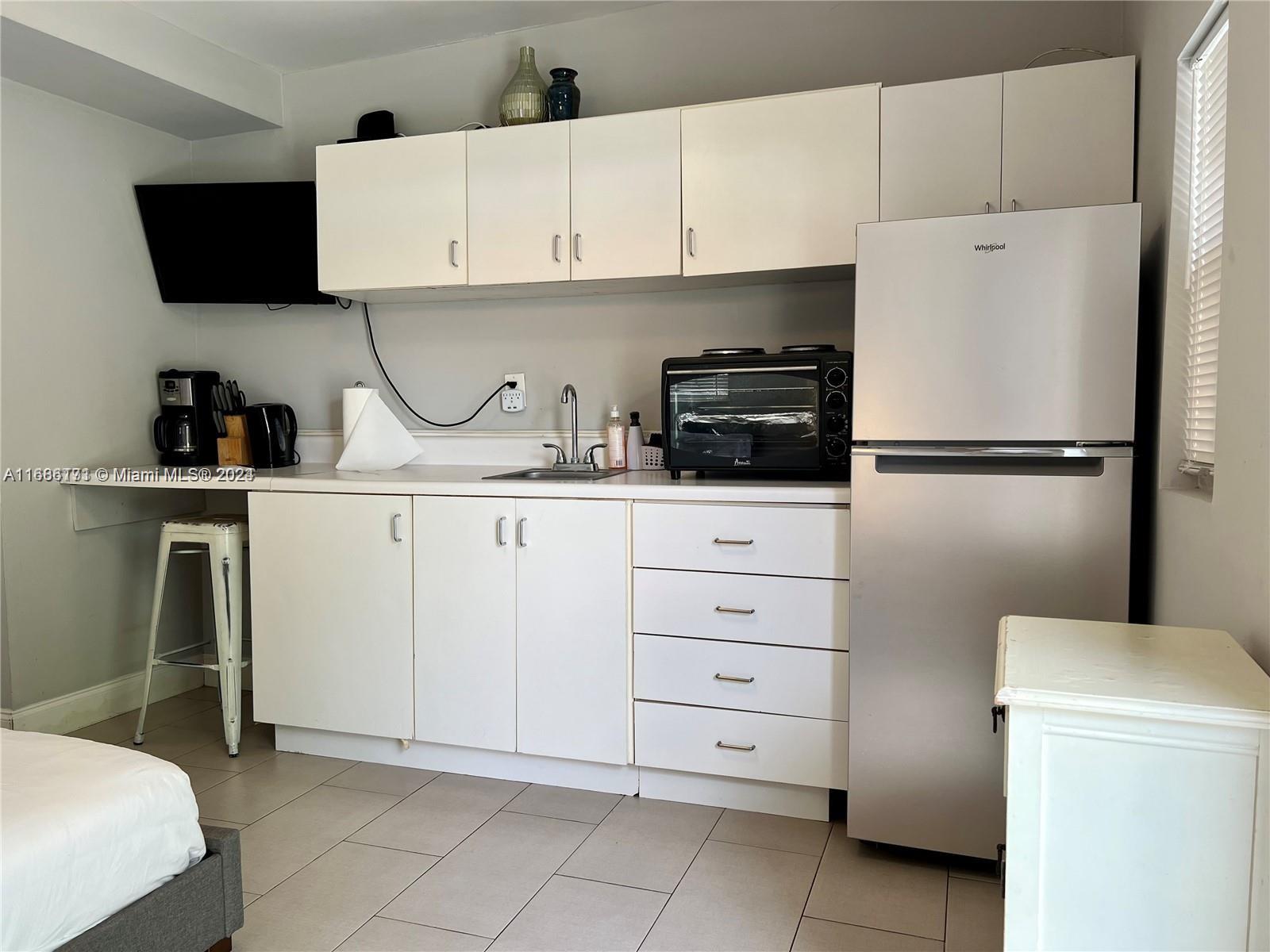 a kitchen with cabinets stainless steel appliances and sink