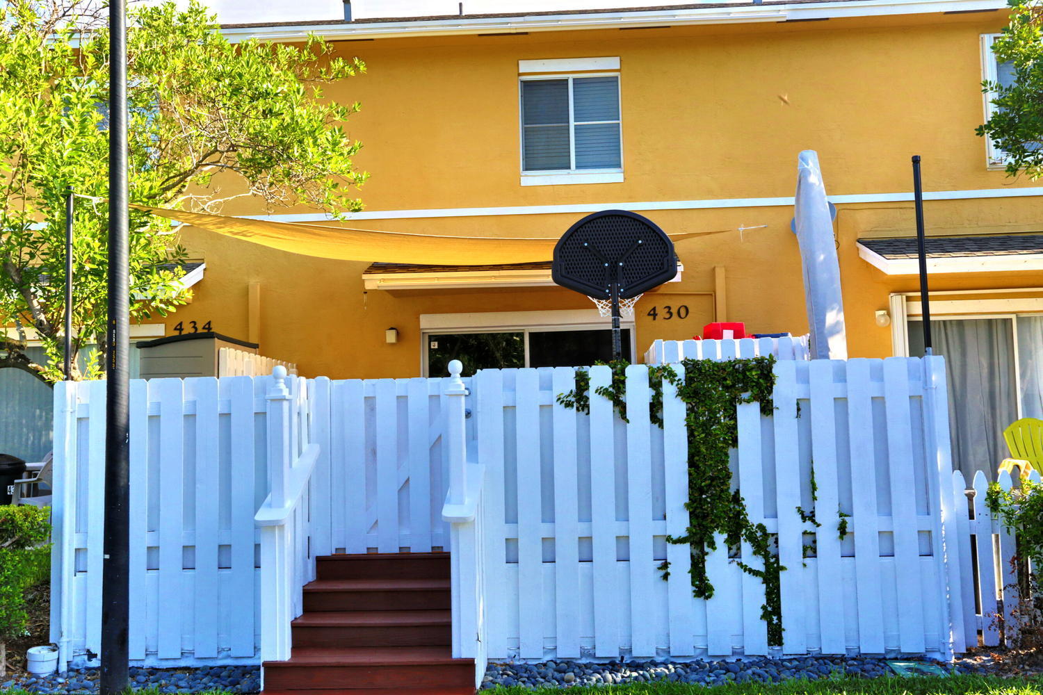 a front view of a house with a garden