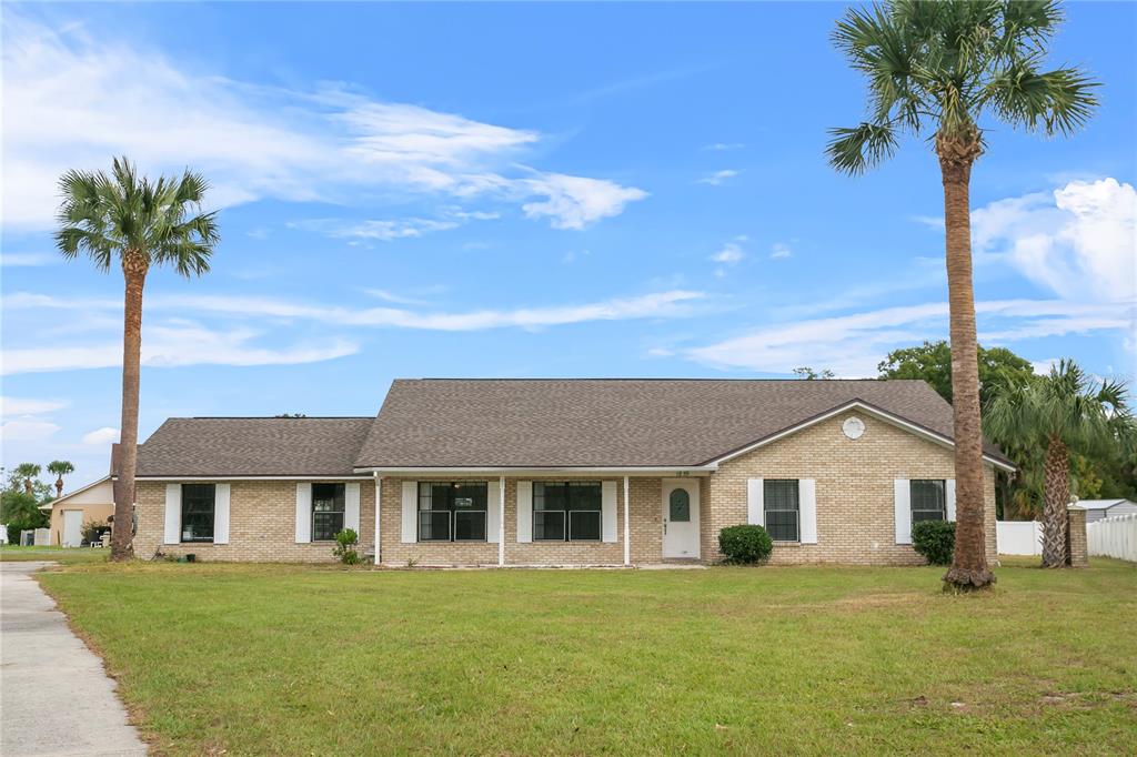 a front view of a house with a garden and yard