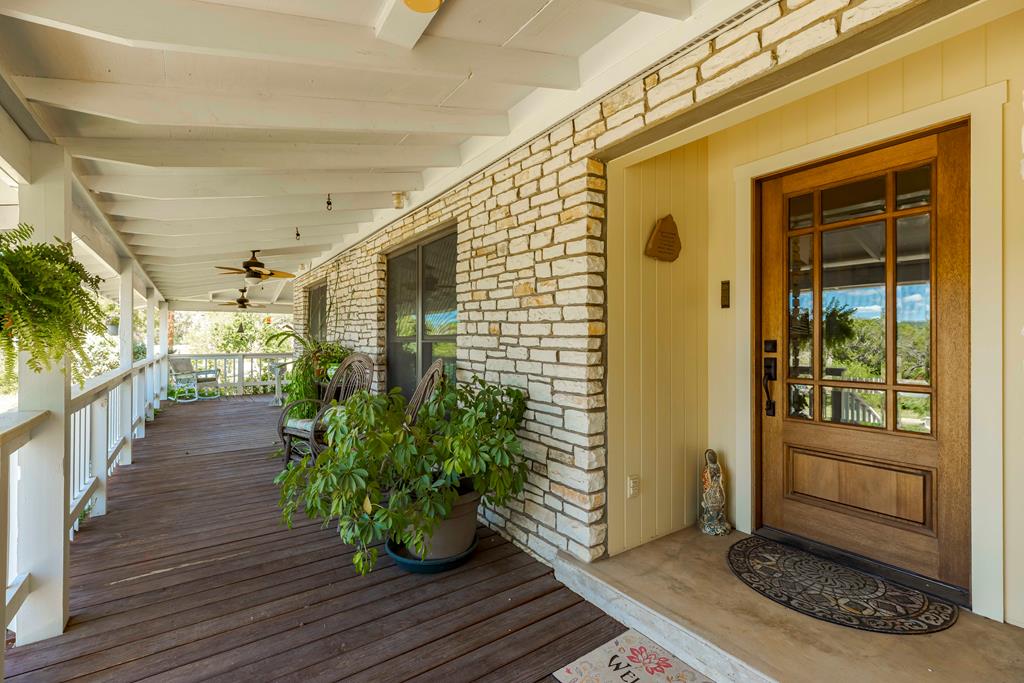 a hallway with wooden floor and front door