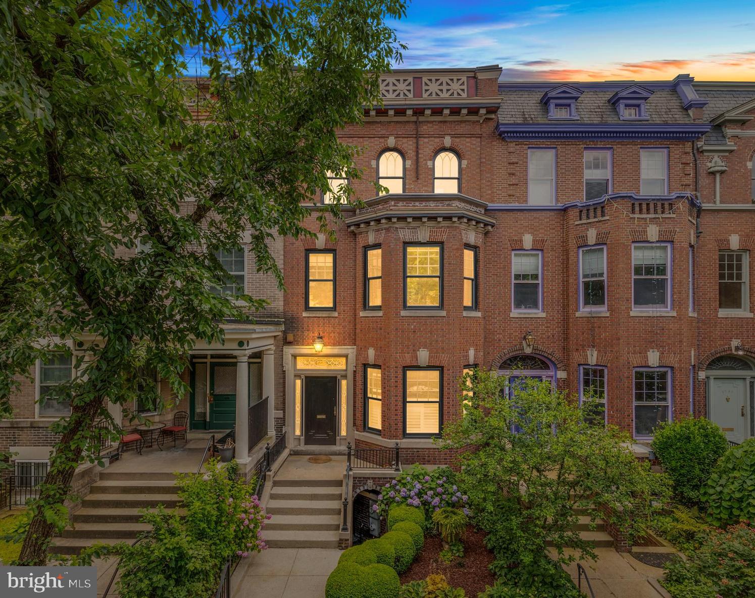 a front view of a residential apartment building with a yard