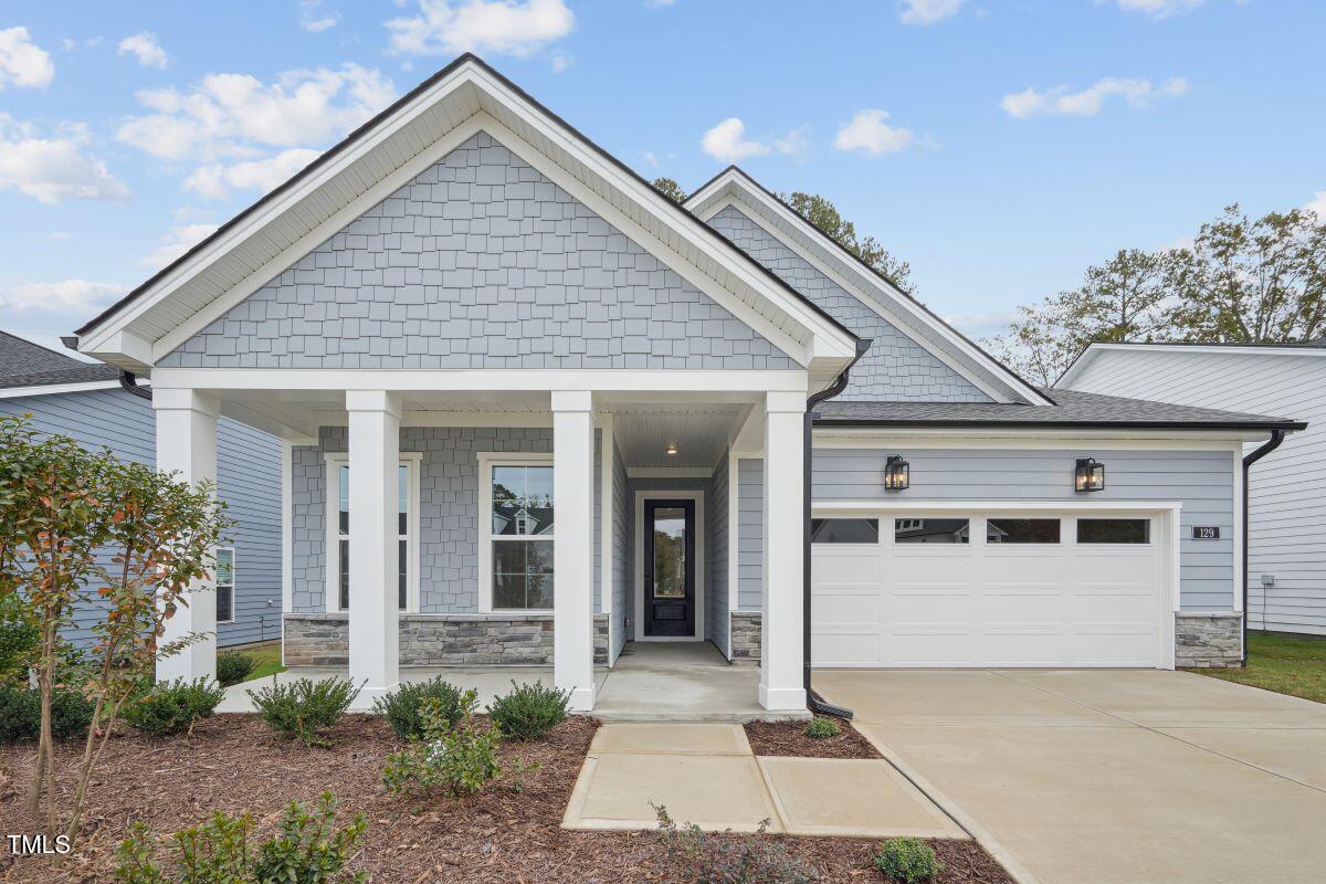 a front view of a house with a garden and entryway