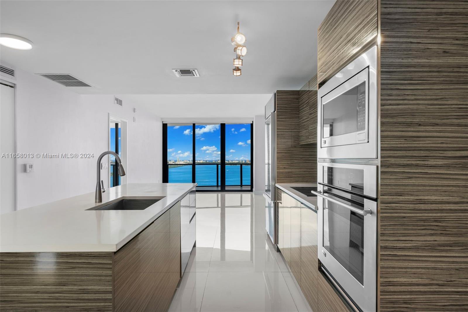 a kitchen with stainless steel appliances granite countertop a sink and a stove