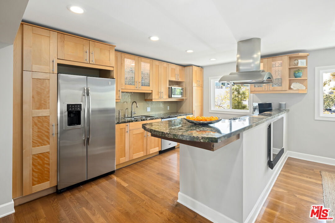 a kitchen with granite countertop a sink appliances and cabinets