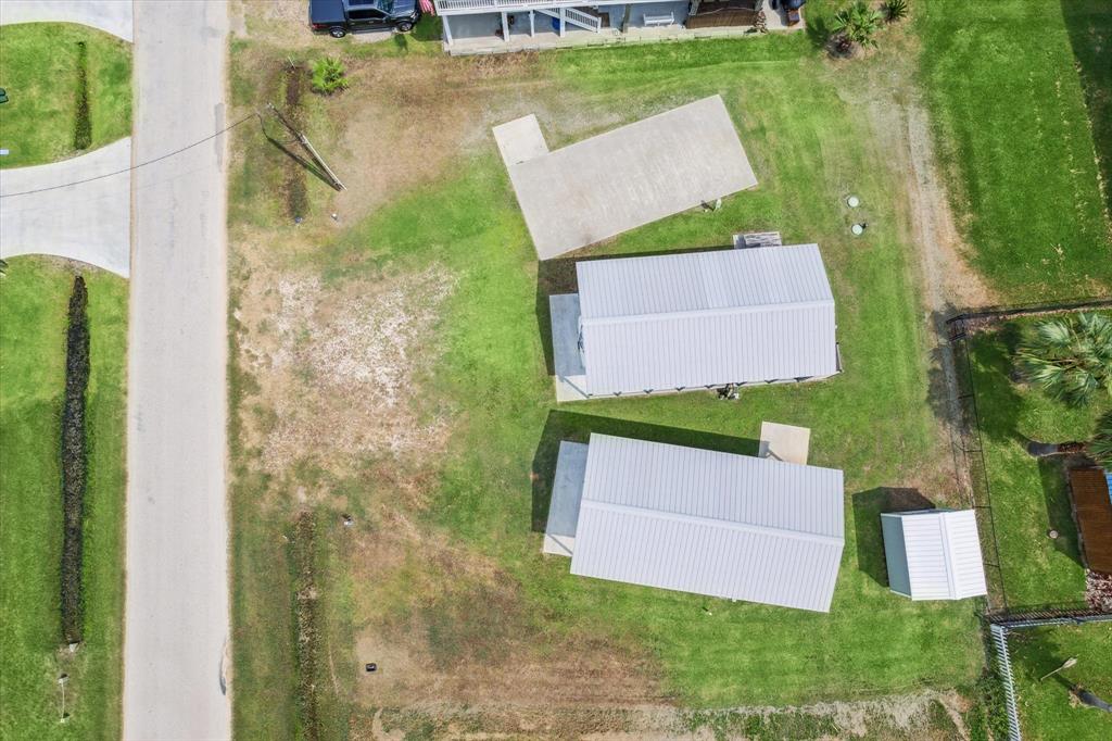 an aerial view of a house with a garden and trees