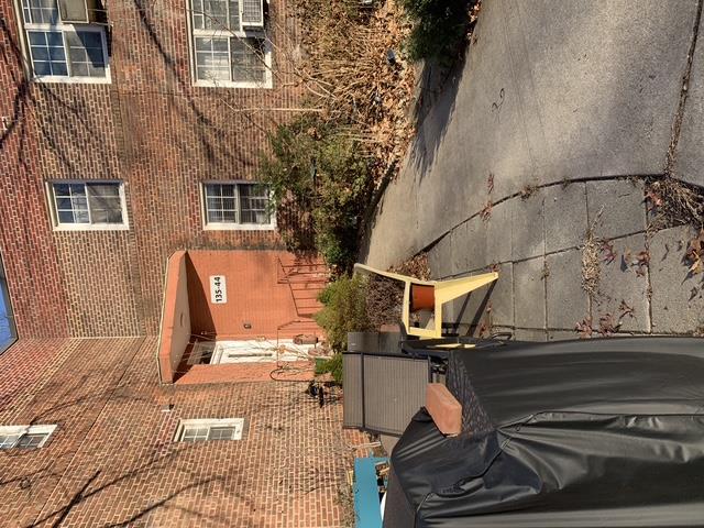 a view of a patio with couches table and chairs and potted plants