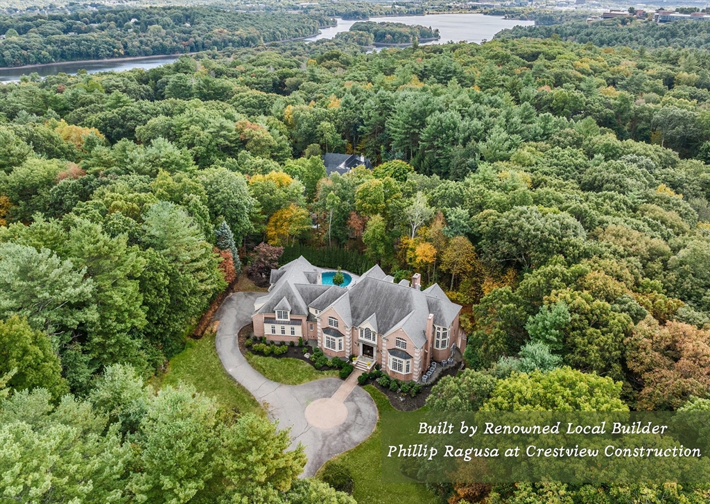 an aerial view of a house with a yard