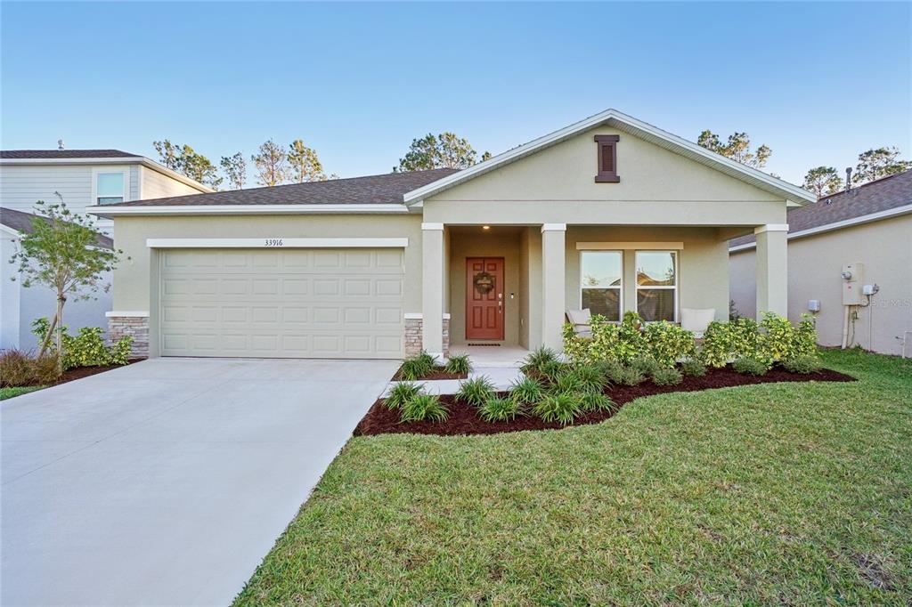 a front view of a house with a yard and garage