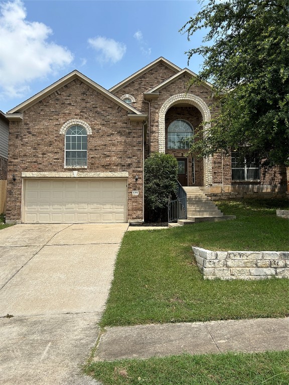 a front view of a house with a yard and garage