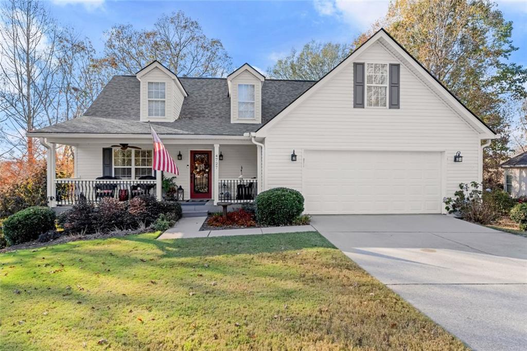 a view of house with yard and outdoor seating