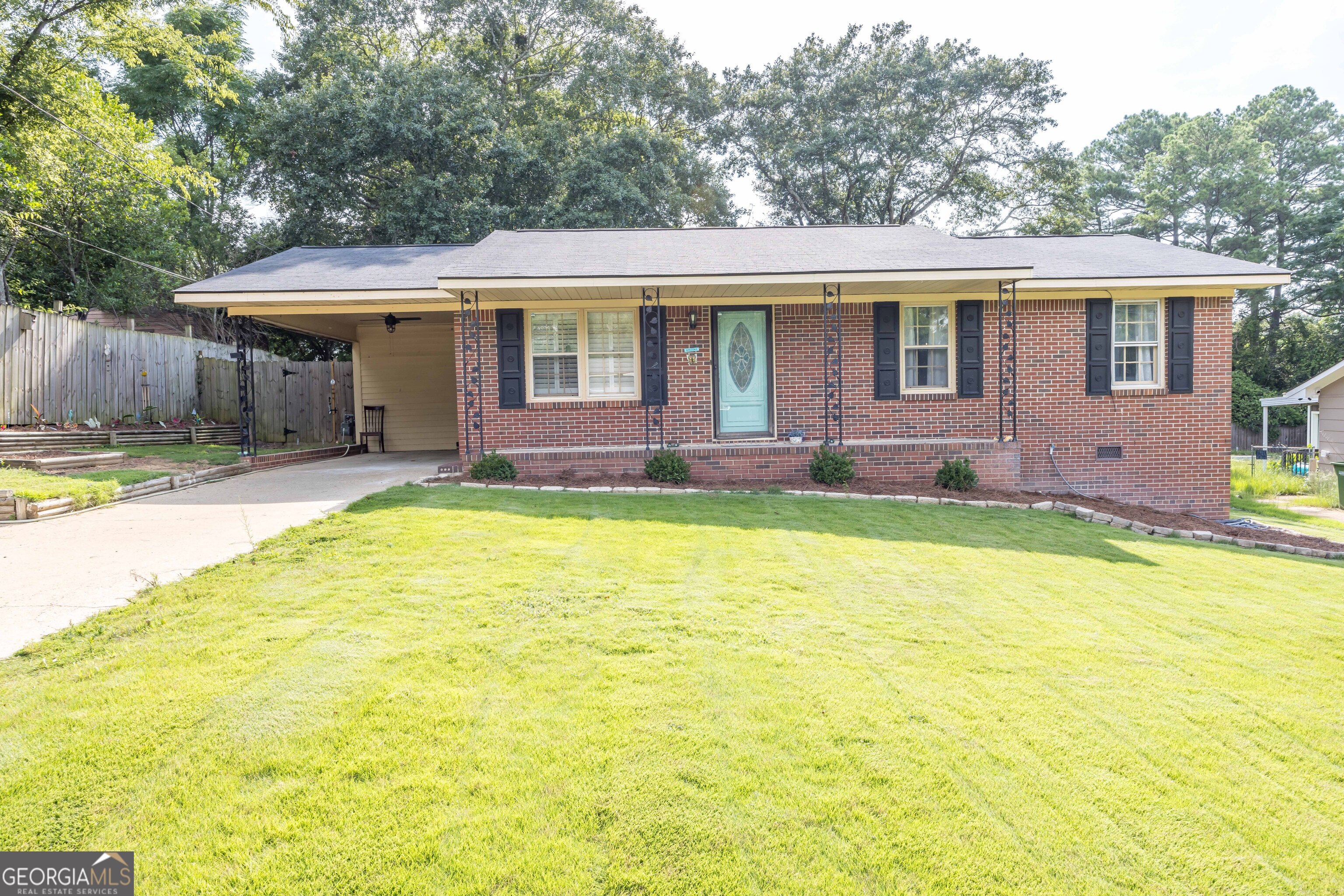 a view of a house with a backyard and a patio