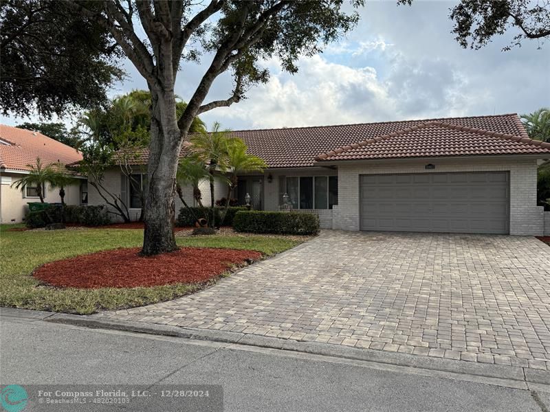 a front view of a house with garage