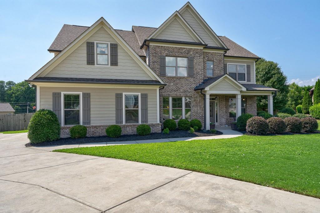 a front view of a house with a yard