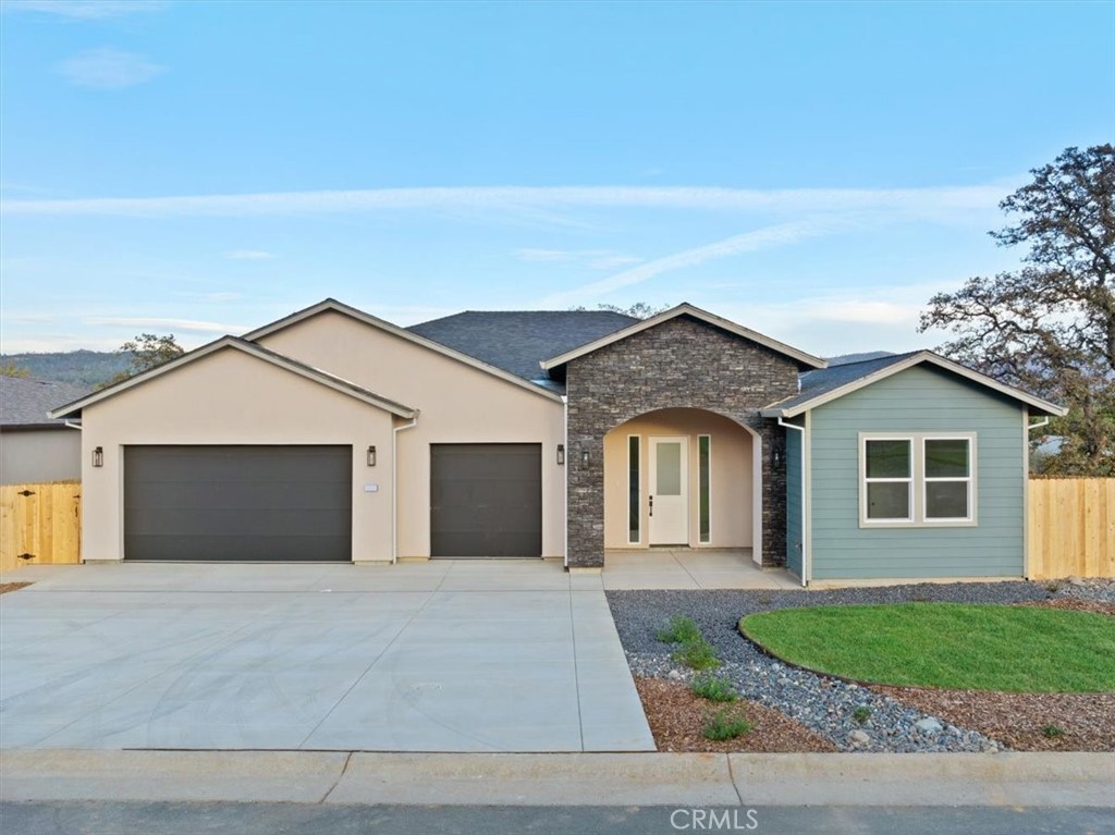 a view of a house with a yard and garage